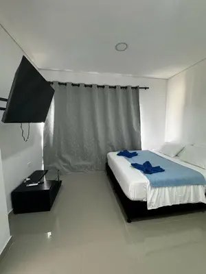 a bedroom with a bed and a lamp and a window at casa real in Cartagena de Indias