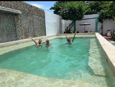 two girls are laying in a swimming pool at casa real in Cartagena de Indias