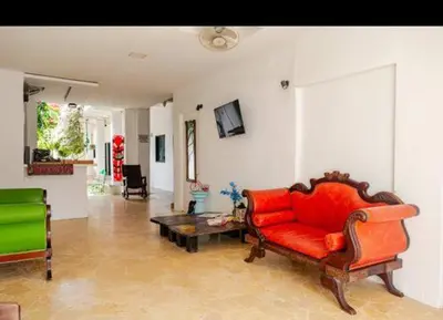 a living room with a red couch and a table at casa real in Cartagena de Indias