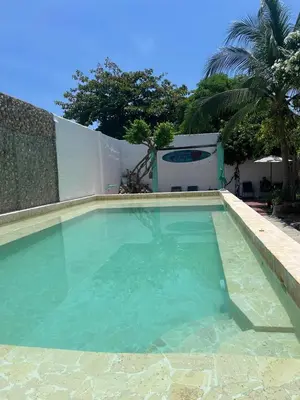 a large swimming pool with green water in a yard at casa real in Cartagena de Indias