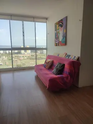 a room with a couch in a room with large windows at Piso apartamento Cartagena de indias in Cartagena de Indias