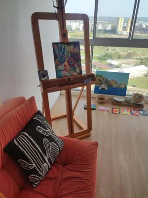 a living room with a painting and a chair at Piso apartamento Cartagena de indias in Cartagena de Indias