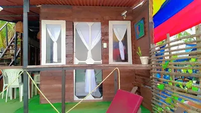a wooden house with windows and a red chair at La playita ocean view in Playa Blanca