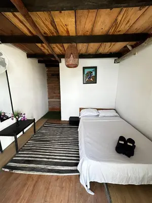 a bedroom with a bed with two black shoes on it at La playita ocean view in Playa Blanca