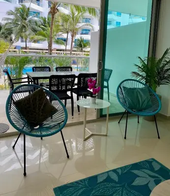 a room with chairs and a table with a view of the ocean at U-GO Morros epic in Cartagena de Indias