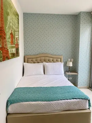 a bedroom with a bed with a blue wall at U-GO Morros epic in Cartagena de Indias