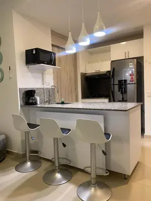 a kitchen with two bar stools and a counter top at U-GO Morros epic in Cartagena de Indias