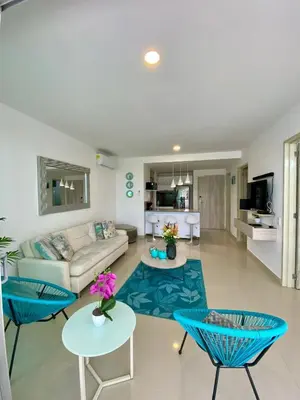 a living room with a white couch and blue chairs at U-GO Morros epic in Cartagena de Indias