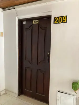 a brown door with a number sign on it at Turipaná 209 in Cartagena de Indias