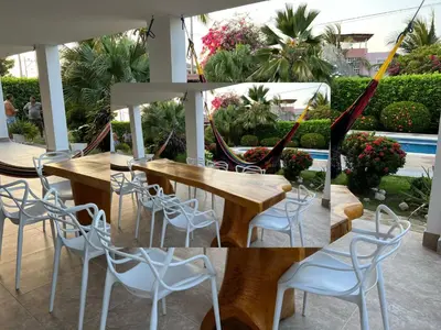 a group of tables and chairs in a patio at House Villa Las Marias in Juan de Acosta