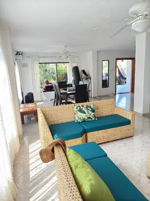 a living room with two couches and a table at House Villa Las Marias in Juan de Acosta