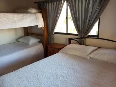 a bedroom with two beds and a window at House Villa Las Marias in Juan de Acosta