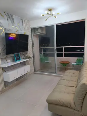 a living room with a couch and a flat screen tv at Torre 811 in Cartagena de Indias