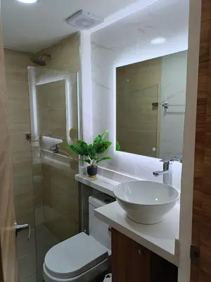 a bathroom with a sink and a toilet and a mirror at Torre 811 in Cartagena de Indias
