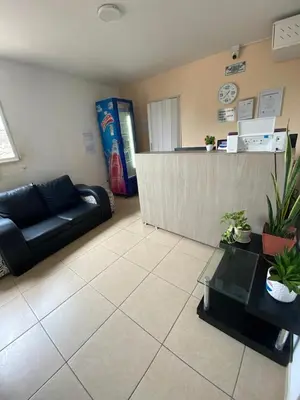 a living room with a couch and a counter at Hotel Prado Cartagena in Cartagena de Indias