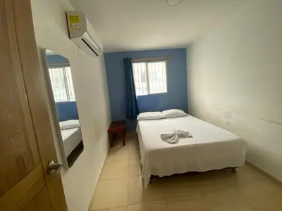 a small room with a bed and a window at Hotel Prado Cartagena in Cartagena de Indias