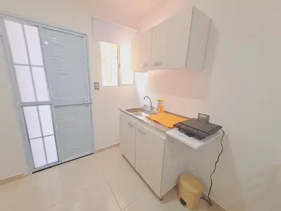 a white kitchen with a sink and a counter at Apartaestudio completo cerca Barranquilla in Galapa