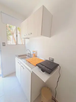 a white kitchen with a sink and a counter at Apartaestudio completo cerca Barranquilla in Galapa