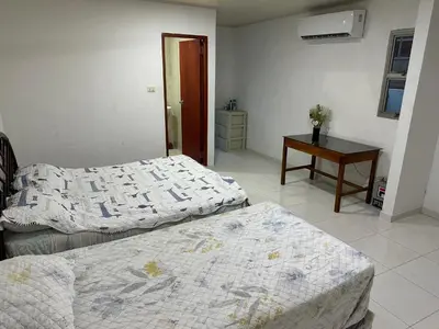 a bedroom with two beds and a table with a table sidx sidx sidx at Habitación en Santiago de Tolú in Santiago