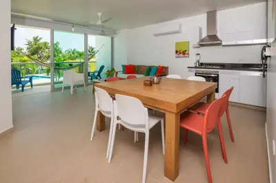 a kitchen and dining room with a wooden table and chairs at Magico Apartamento Frente al Mar 3 Habitaciones MSC22 in Coveñas