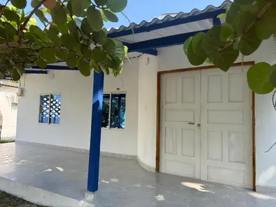 a garage with a blue pole in front of it at Cabaña MARDELA Casa de Playa in San Antero