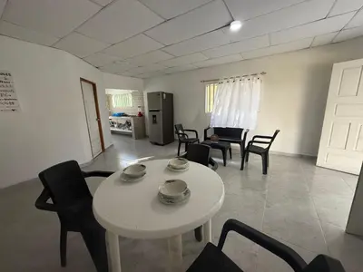 a living room with a white table and chairs at Cabaña MARDELA Casa de Playa in San Antero