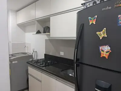 a kitchen with a black refrigerator with magnets on it at Aqualina 911 in Cartagena de Indias