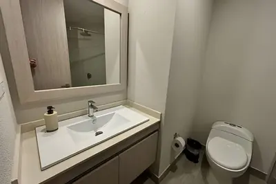 a bathroom with a sink and a toilet and a mirror at Dominique in Cartagena de Indias