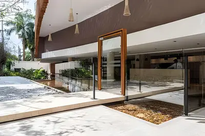 an open glass door to a building with a fountain at Dominique in Cartagena de Indias