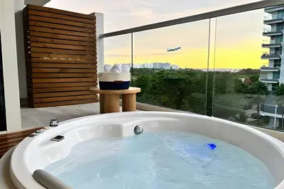 a bath tub in a bathroom with a large window at Dominique in Cartagena de Indias