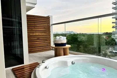 a bath tub in a bathroom with a large window at Dominique in Cartagena de Indias
