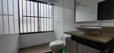 a bathroom with a sink and a toilet and a mirror at Live Stay - Cartagena Escape Plaza in Cartagena de Indias