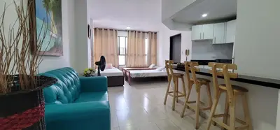 a living room with a blue couch and a kitchen at Live Stay - Cartagena Escape Plaza in Cartagena de Indias