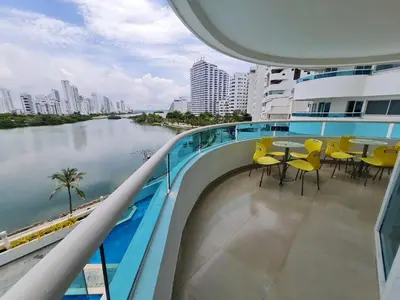a balcony with tables and chairs and a river at Apartamento con la mejor vista Cartagena in Cartagena de Indias