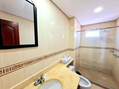 a bathroom with a sink and a toilet and a mirror at Apartamento con la mejor vista Cartagena in Cartagena de Indias