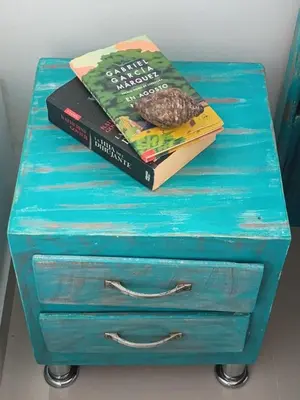 two books sitting on top of a blue dresser at Coveñas Family Haven in Coveñas