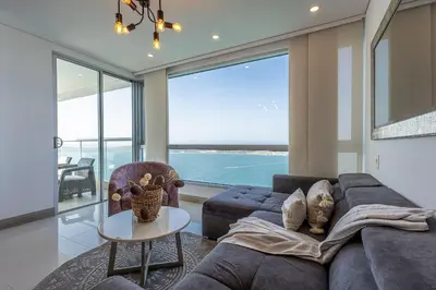 a living room with a couch and a table at Laurhomes Laguito Floor 33, 3HBT in Cartagena de Indias
