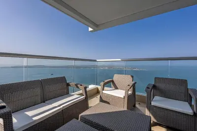 a balcony with chairs and a view of the ocean at Laurhomes Laguito Floor 33, 3HBT in Cartagena de Indias