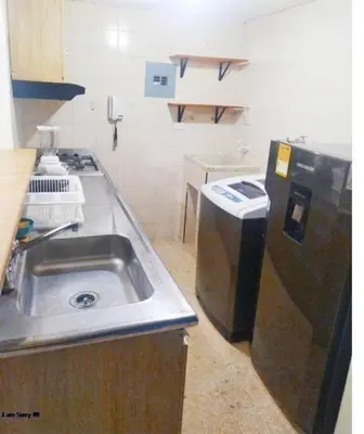 a small kitchen with a sink and a refrigerator at apto al frente del mar p11 in Cartagena de Indias