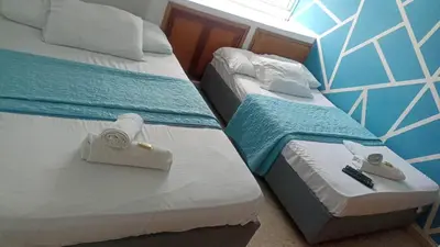 two beds in a hotel room with towels on them at apto al frente del mar p11 in Cartagena de Indias