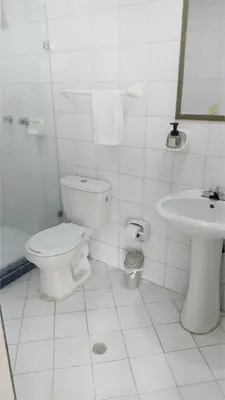 a white bathroom with a toilet and a sink at apto al frente del mar p11 in Cartagena de Indias