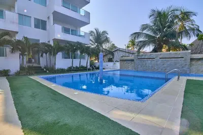 a swimming pool in front of a building at Hermoso Apartamento Frente al Mar 3 Habitaciones B62 in Coveñitas