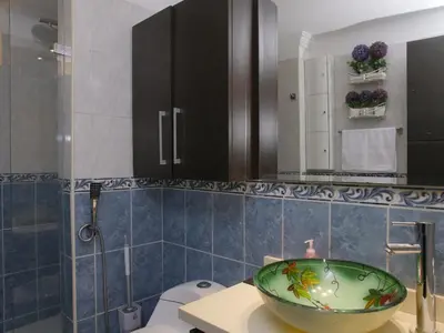 a bathroom with a bowl sink and a toilet at Historic Cartagena 2BR Apt in Cartagena de Indias