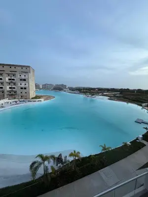 a large pool of blue water next to the ocean at Baia Kristal in Cartagena de Indias