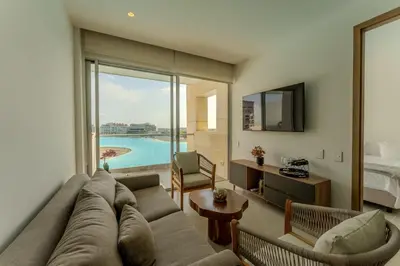 a living room with a couch and a large window at Baia Kristal in Cartagena de Indias