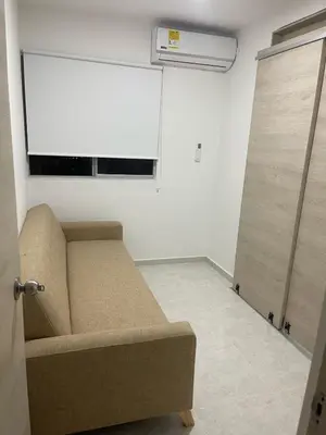 a living room with a couch and a window at Apartamento en Cartagena in Cartagena de Indias