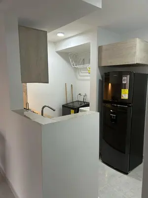 a kitchen with a black refrigerator and a sink at Apartamento en Cartagena in Cartagena de Indias