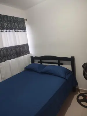 a bedroom with a bed with blue pillows at Summer 811 in Cartagena de Indias