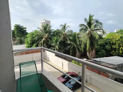 a balcony with a green railing and palm trees at Summer 811 in Cartagena de Indias