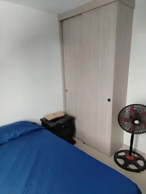 a bedroom with a blue bed and a chair at Summer 811 in Cartagena de Indias